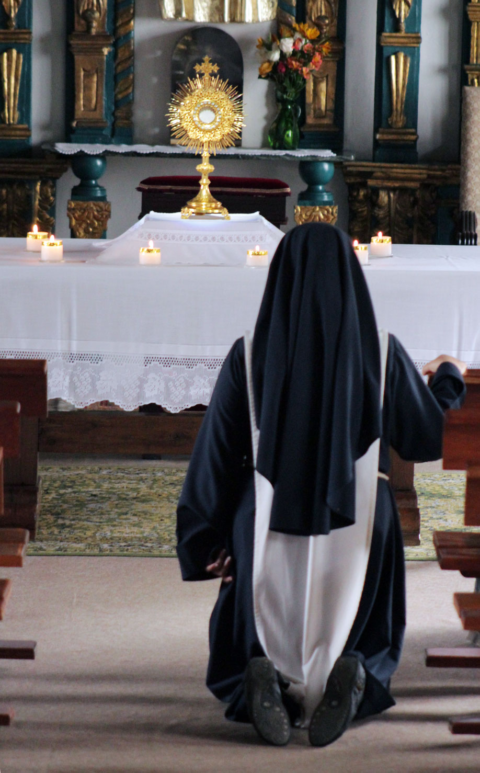 Preachers of Christ and Mary sister praying in Eucharistic adoration before the Blessed Sacrament in Brooklyn